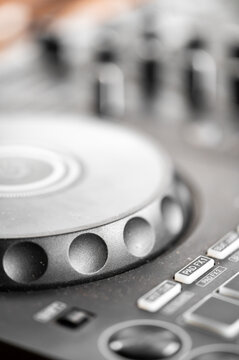 Close-up of a professional DJ controller jog wheel, featuring pad FX buttons in sharp focus with a blurred background. Perfect for music, nightlife, and entertainment concepts.
