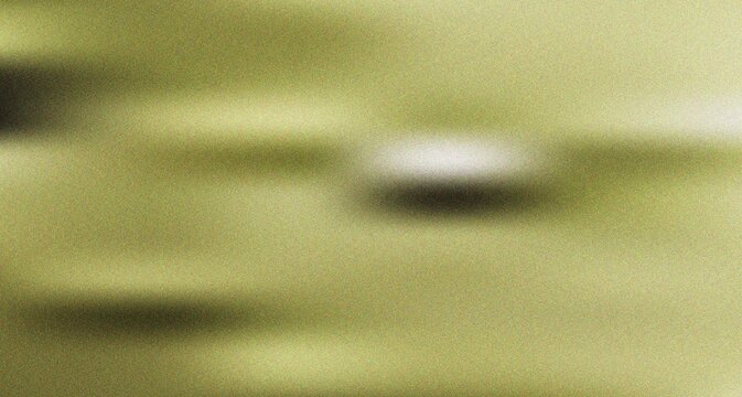 Bright yellow green abstract blur with a central soft light spot creating a dynamic and energetic visual texture