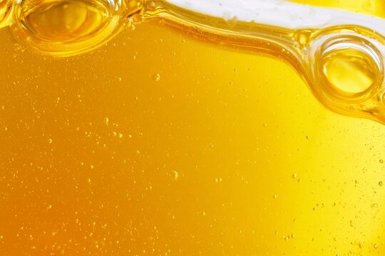 Golden liquid bubbles in a glass creating patterns of movement