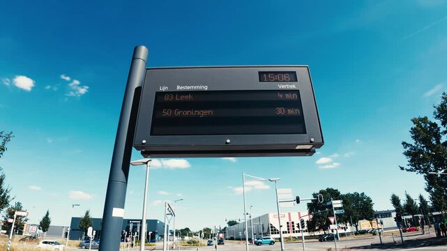 Electronic public transport schedule board displaying bus destinations, routes (line 83 to Leek via Norg and Roden, line 50 to Groningen via De Punt), and departure times in Assen, Netherlands.