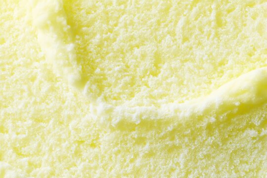 Creamy texture of yellow dessert with smooth waves in a bowl