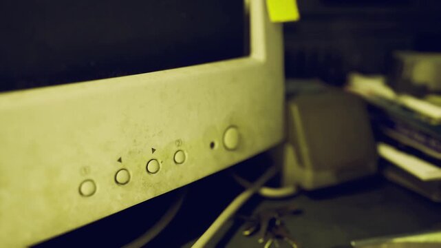 Closeup of old CRT monitor. Dusty surface with aging control buttons. Signs of aging and dust accumulation on old CRT monitor with control buttons