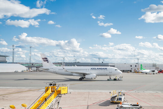 Stockholm, Sweden &mdash; August 1, 2026: Icelandair passenger aircraft is towed across the airport apron while ground service vehicles operate nearby at Stockholm Arlanda Airport.