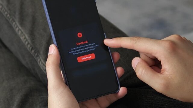Mortgage application is declined on a smartphone, highlighting tighter lending standards, housing affordability pressure and the growing role of digital credit decisions.