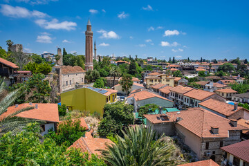 Fototapeta premium Panoramic Kaleici rooftops with a mosque minaret beneath summer clouds in Antalya, Turkey.