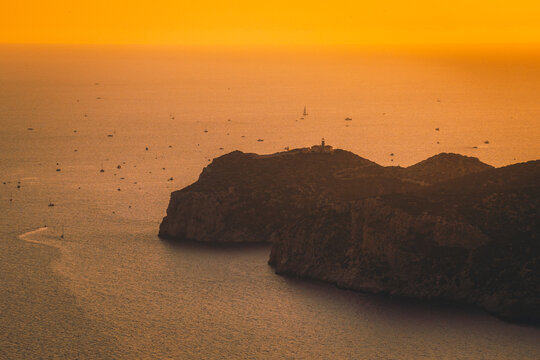 Sant Elm, Spain - 12 August 2026: Aerial view of the total solar eclipse over Sa Dragonera island with numerous boats gathered in the surrounding sea during the golden hour.