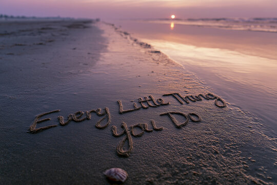 Every Little Thing You Do Handwritten in Coastal Sand with Soft Depth and Seashell Accent at Sunset &ndash; perfect for lyric inspired art