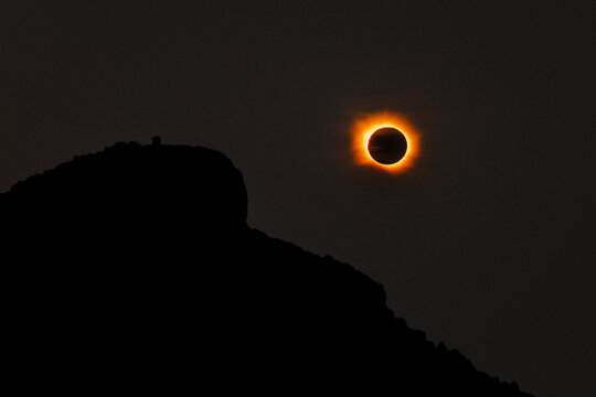 Sant Elm, Spain - 12 August 2026: Aerial view of the total solar eclipse over the silhouette of Sa Dragonera island, capturing the corona and the dark moon.
