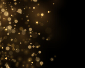Abstract gold sparkles scatter across a black background. Glowing particles add energy. Modern celebration design. © Extrastock