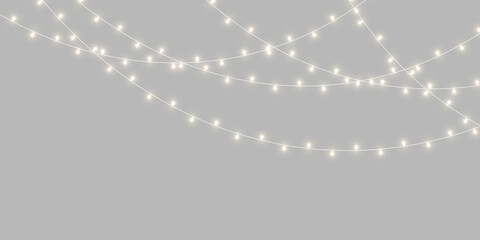 PNG holiday garland featuring warm glowing bulbs and delicate golden wire. Transparent background offers flexible placement. Great for Christmas artwork. © Extrastock