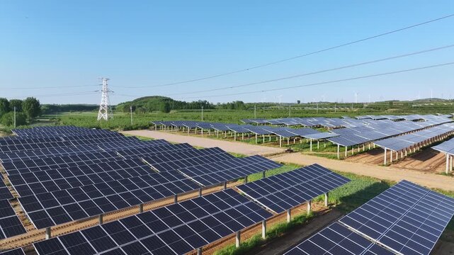 Large scale photovoltaic power station array under clear blue sky in rural farmland landscape