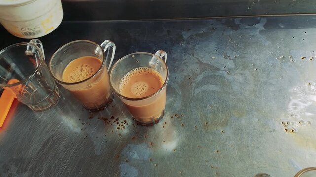 Traditional Bangladeshi street food style sweet condensed milk tea brewed at a local roadside tea stall