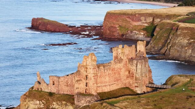 Dramatic ancient castle ruins on the scottish coastline