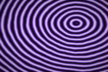Naklejka premium Purple concentric circle pattern with subtle distortion creating abstract ripple effect on dark background