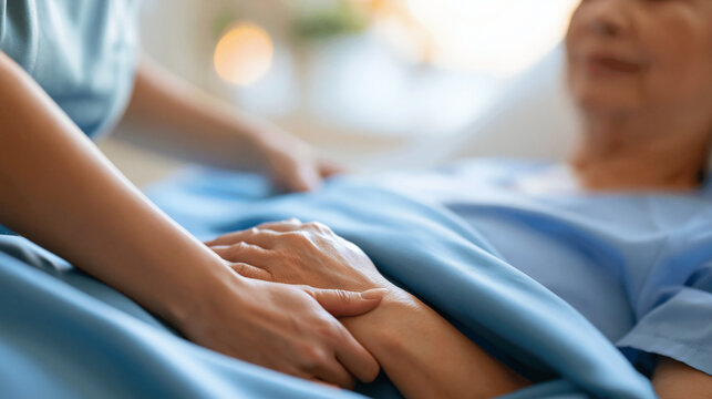 close-up of a caregiver's hands tucking a blanket gently around a patient in bright even lighting, face out of frame, compassionate patient support concept, hospice care, comfort,