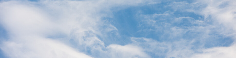 Obraz premium Ethereal white feathery cirrus clouds in a blue sky, as a texture pattern nature background 