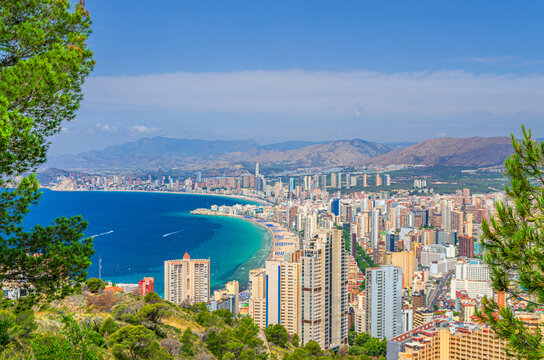 Benidorm cityscape, aerial view of Old town Benidorm city historic centre coastline with skyscrapers, hotel buildings, beach on Costa Blanca coast Mediterranean Sea azure water in summer day, Spain