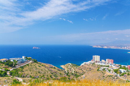 Aerial panoramic view of Benidorm bay Mediterranean Sea azure water, Costa Blanca coastline Benidorm city coast, buildings in Serra Gelada natural park in summer day, Valencian Community, Spain