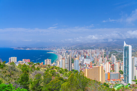 Aerial panoramic view of Old town Benidorm city historic centre coastline with skyscraper buildings on Costa Blanca coast Mediterranean Sea and Sierra Cortina mountain range in summer day, Spain