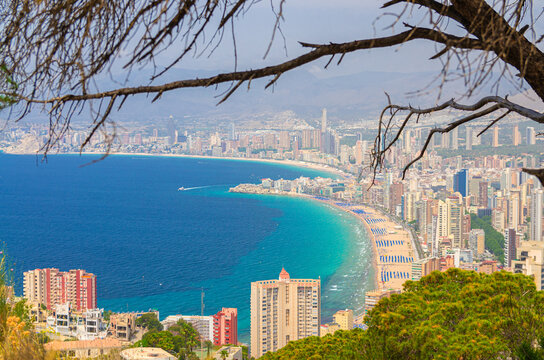 Benidorm cityscape, aerial view of Old town Benidorm city historic centre coastline with skyscrapers, hotel buildings, beach on Costa Blanca coast Mediterranean Sea azure water in summer day, Spain
