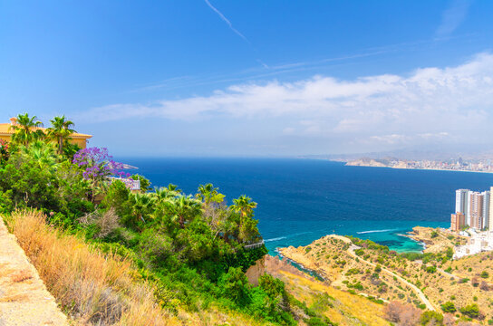 Aerial view of Benidorm bay Mediterranean Sea azure water, Costa Blanca coastline Benidorm city coast, slope Serra Gelada natural park, Cala Almadraba and Cala Tio Ximo coves in summer day, Spain