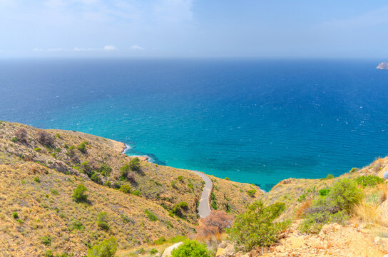 Aerial view of Cala Tio Ximo cove Benidorm bay Mediterranean Sea azure turquoise water, Costa Blanca coastline coast and road in Serra Gelada natural park in summer day, Valencian Community, Spain