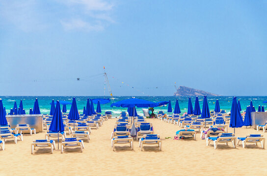 Levante sandy beach with chaise lounge and umbrellas, Playa Platja De Llevant in Benidorm city centre on Costa Blanca coast Mediterranean Sea horizon in summer day, Valencian Community, Spain