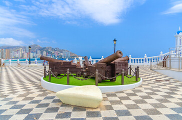 Fototapeta premium Cannons monument on Placa de Santa Anna square Mediterranean Balcony El Castell Old town Benidorm city historic centre in summer day, Valencian Community, Spain