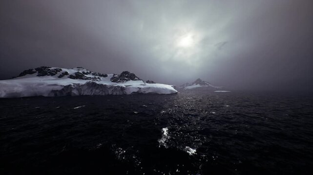 Glittering sea path leading to peak, reflective trail cuts through dark water toward distant summit, atmospheric light and mist create journey and discovery