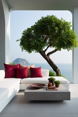 Fototapeta premium Modern coastal terrace lounge with white sofa and red cushions overlooking sea and sculpted tree for interior design background and summer relaxation banner