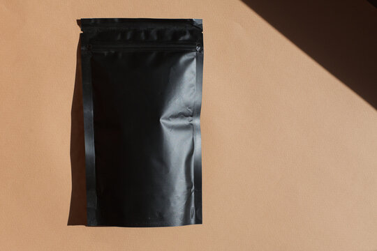 Blank craft plastic pouch, white pack on studio background with shadow, mylar bag isolated for coffee or food, cosmetic products, snack, candy. Different sizes, mock up.