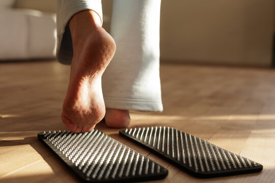 Woman Practicing Sadhu Board Nail Meditation For Stress Relief At Home