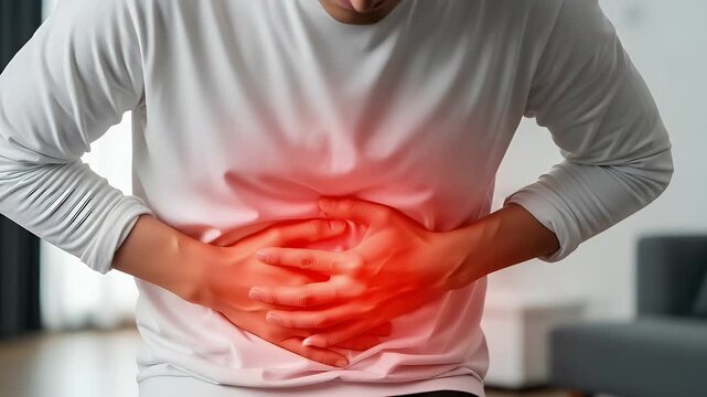 Person experiencing severe abdominal pain with hands pressed against stomach and a red hot area indicating discomfort and suffering