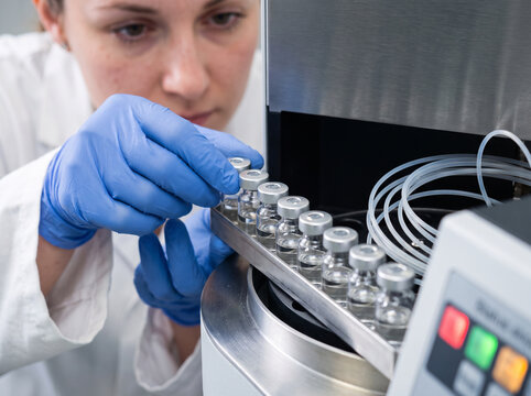 Analyst preparing sample vials for chromatography quality testing