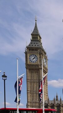 London, Tower of Big Ben on Parliament Square with flags waving in front of it, Great Bell of Clock