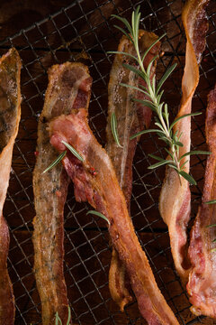 Cooked Greasy Bacon on a wood board