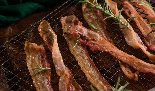 Cooked Greasy Bacon on a wood board