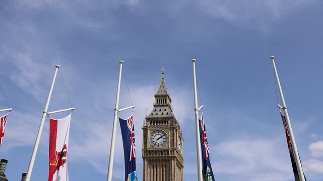 London, Tower of Big Ben on Parliament Square with flags waving in front of it, Great Bell of Clock