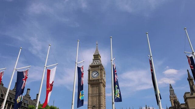 London, Tower of Big Ben on Parliament Square with flags waving in front of it, Great Bell of Clock