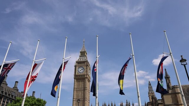 London, Tower of Big Ben on Parliament Square with flags waving in front of it, Great Bell of Clock