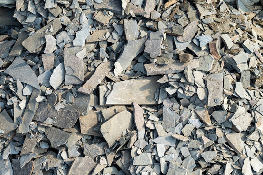 Quebec, Canada, 28 July 2026 : A close-up view shows a pile of broken, flat slate pieces and rock fragments.