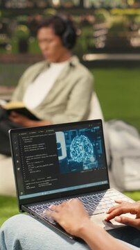 Vertical frame: The student uses binary code and AI on a laptop, programming language with machine learning and neural networks, during solo study on a modern campus, reflecting student life.