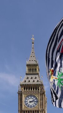 London, Tower of Big Ben on Parliament Square with flags waving in front of it, Great Bell of Clock
