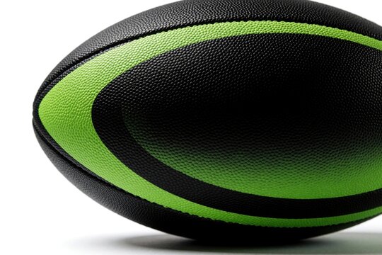 Close up view of professional rugby ball. Black, lime green textured surface shows detailed pattern. Oval sports equipment sits on white background. High contrast design makes look modern, vibrant
