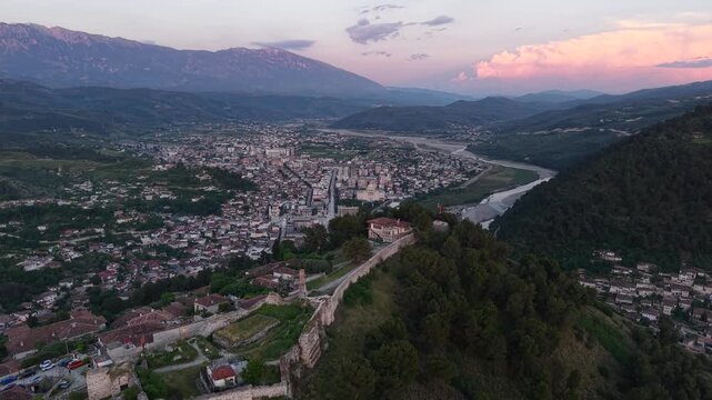 Aerial view of the historic Berat Castle and the surrounding town of Berat, featuring stone walls, traditional rooftops, and the Osum River in Berat, Qarku i Beratit, Albania.