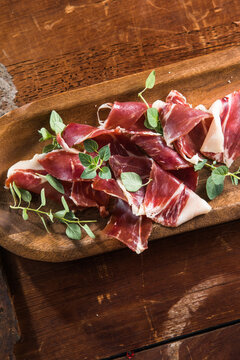 Italian prosciutto crudo or jamon with rosemary. Raw ham appetizer