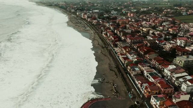 Raging ocean wave destroy buildings, causing climate change and illegal building