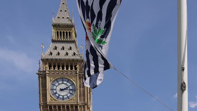 London, Tower of Big Ben on Parliament Square with flags waving in front of it, Great Bell of Clock