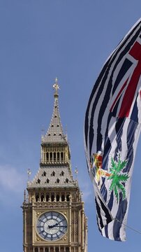 London, Tower of Big Ben on Parliament Square with flags waving in front of it, Great Bell of Clock