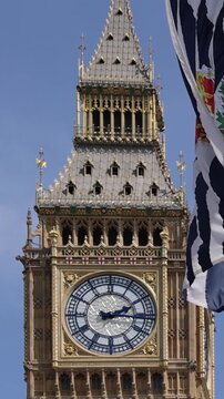 London, Tower of Big Ben on Parliament Square with flags waving in front of it, Great Bell of Clock